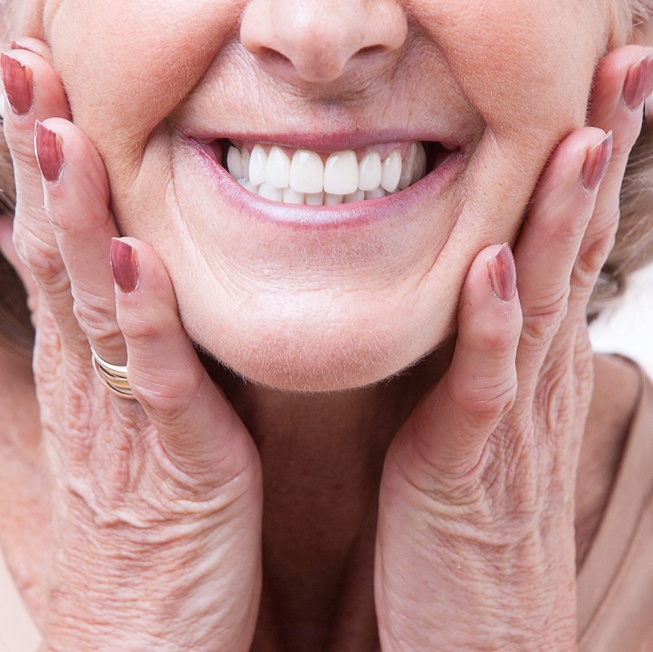 A close-up of a senior woman wearing dentures