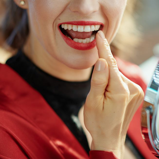 Patient pointing to tooth after cosmetic bonding