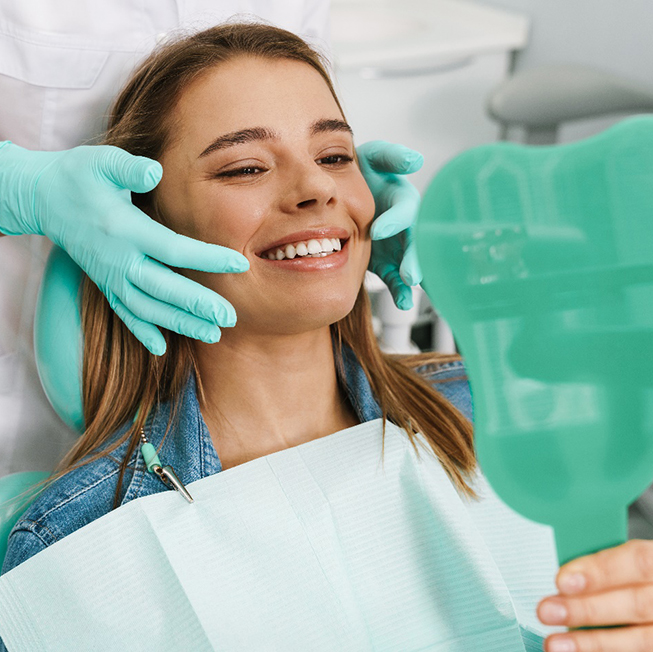 woman smiling after getting a dental bridge in Corpus Christi 