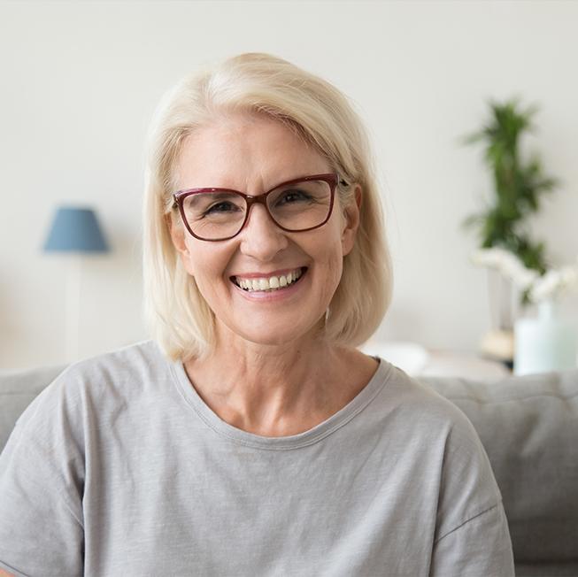 Woman sharing healthy smile after dental checkup and teeth cleaning