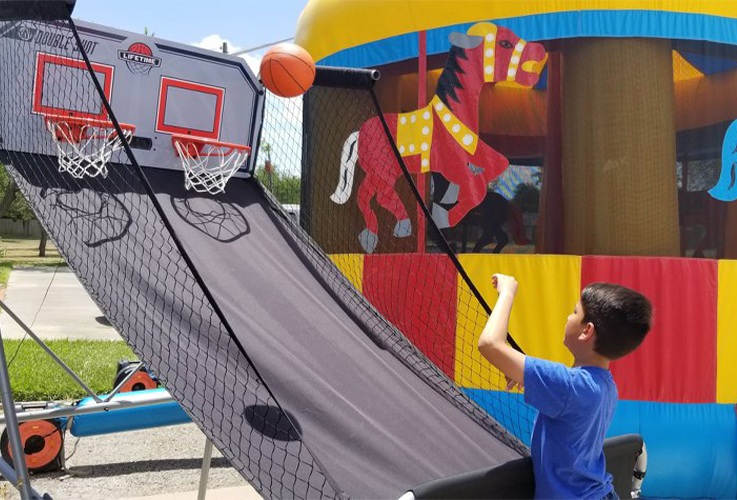 Kids playing basketball at community event