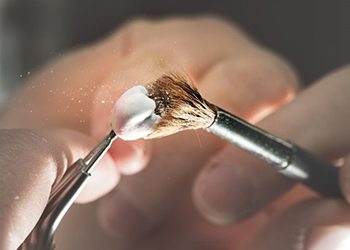 Dental lab technician working on crown