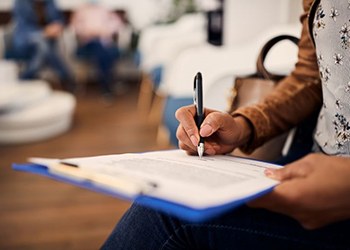 Patient filling out paperwork in dental office