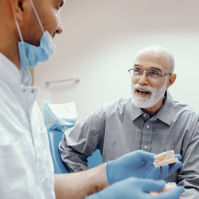Dentist discussing cost of dentures in Corpus Christi with patient