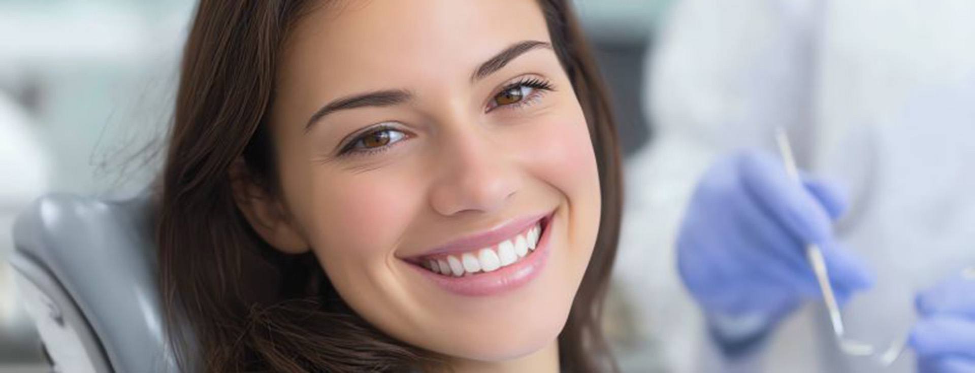 Happy, smiling dental patient in treatment chair