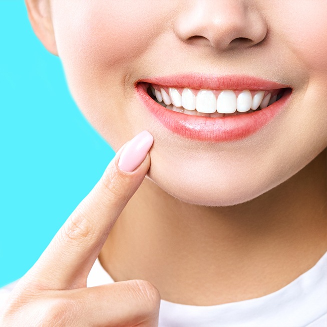 Woman pointing to smile after icon treatment