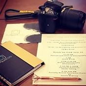 Camera notebook and paper on desk