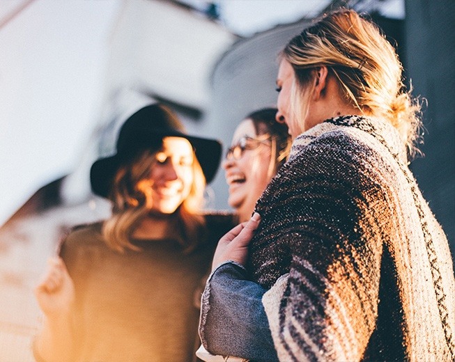 Group of friends laughing together with healthy smiles after dental visit