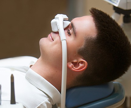 Smiling patient breathing in nitrous oxide