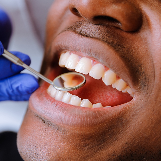 Man receiving oral cancer screening