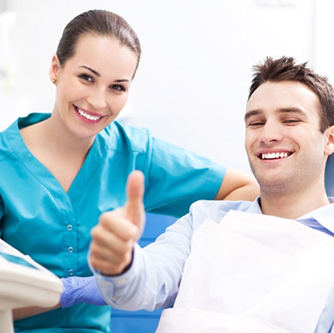 patient giving a thumbs up after understanding the cost of his smile makeover