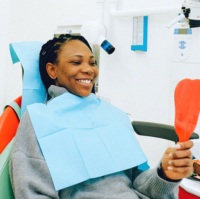 Woman at dentist looking in mirror