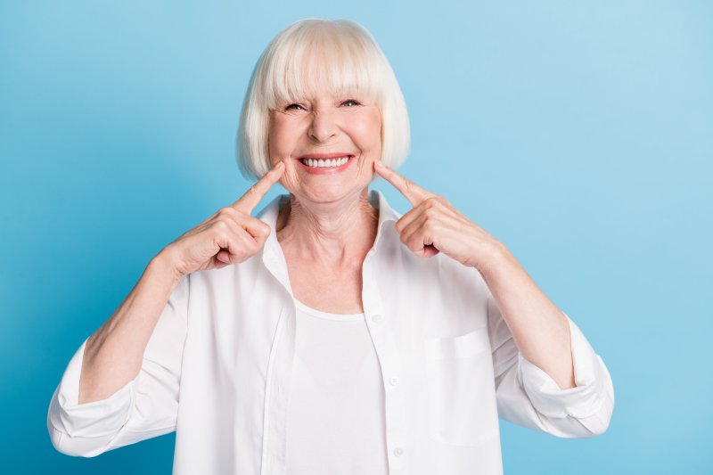 An older woman smiling with her new dentures
