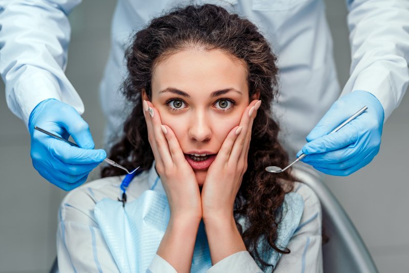A woman feeling fear toward her dentist