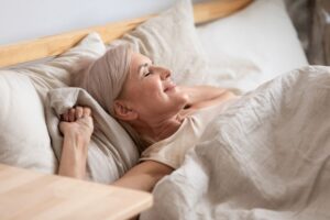 Healthy senior woman waking up refreshed